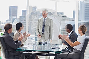 Colleagues applauding the boss during a meeting