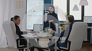 Colleagues attending business meeting in boardroom