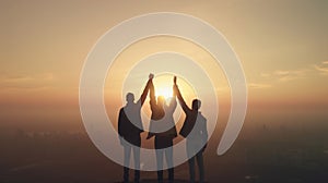 Colleagues come together in triumph, hands raised against a backdrop of a beautiful sunset