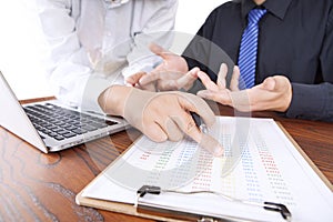 Colleagues discussing work in office