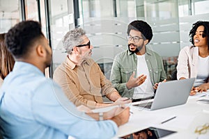 Colleagues engage in a lively exchange of ideas in an office