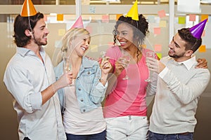 Colleagues enjoying birthday party with champagne