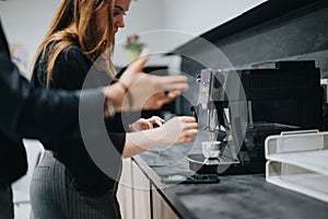 Colleagues enjoying a coffee break together in a modern office kitchen