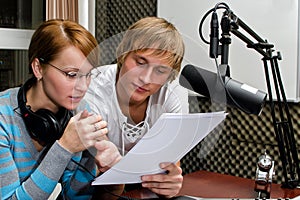 Colleagues examine broadcast list