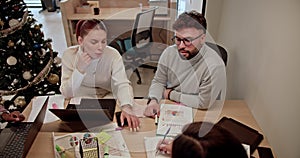 Colleagues in a festive office environment actively engaging in brainstorming, sharing ideas, and project strategizing.