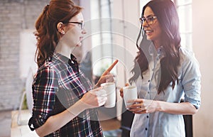 Colleagues having coffee break in modern office