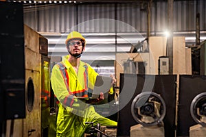 Colleagues in industrial engineering or management of work done Holding a male mechanic. Technicians or engineers are inspecting