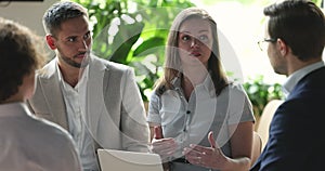 Colleagues listening to female team leader or boss during briefing