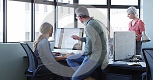 Colleagues, manager and office with computers, conversation and pointing at pc screen. Men, women and coworkers for