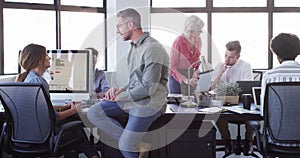 Colleagues, manager and office with computers, conversation and pointing at pc screen. Men, women and coworkers for