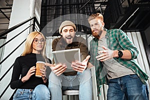 Colleagues in office using tablet computer