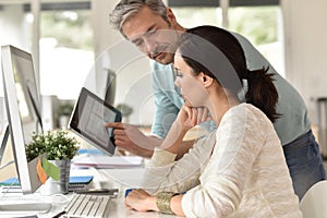 Colleagues in office working on desktop