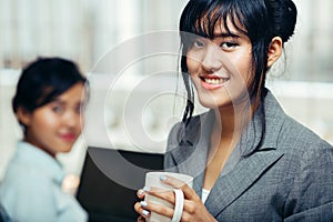 Colleagues relaxing with hot coffee