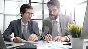 colleagues are sitting at a table in a modern office corridor