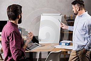 colleagues talking and looking at flipchart