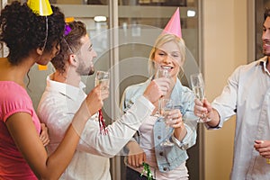 Colleagues toasting champagne in birthday party