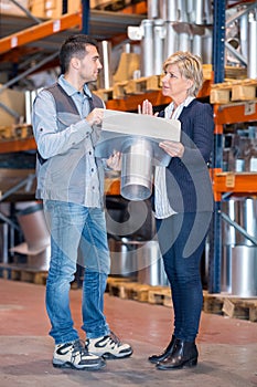colleagues in warehouse looking at product photo