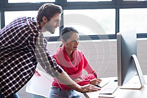 Colleagues working on computer in office