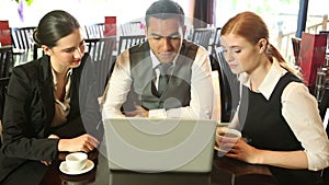 Colleagues working together while having coffee in a restaurant