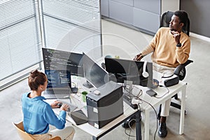Colleagues writing computer codes on computers