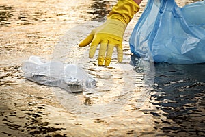 Collect garbage beach. Cleaning trash beach waste plastic PET bottle plastic pollution. Volunteer cleaning river trash