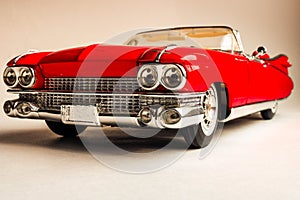 Collectible toy car model. Red retro car 1959. Classic toy model.