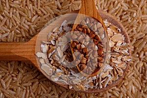 Collecting dry cereals. Buckwheat, rice, oatmeal in a large brown plate.