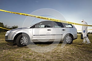 Collecting of evidences and traces by criminologist around car