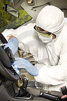 Collecting of odor traces by criminologist from driving wheel