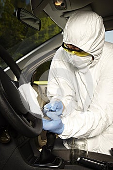 Collecting of odor traces by criminologist from driving wheel