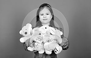 Collecting toys hobby. Cherishing memories of childhood. Childhood concept. Small girl smiling face with toys. Happy photo