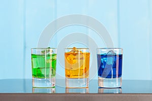 Collection of alcoholic cocktails in shot glasses