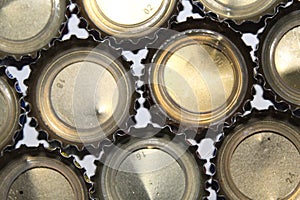 A collection of aluminum lids on soft drinks