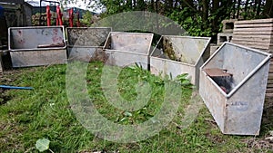 A collection of animal feeding troughs