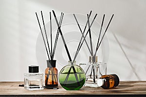 A Collection of Aromatic Reed Diffusers on a Wooden Table Against a Neutral Background photo