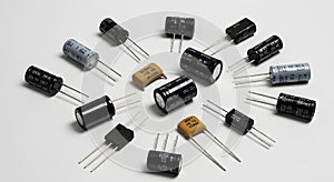 Assorted electronic capacitors on white background
