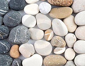 Collection of Assorted Smooth Gray and White Pebbles Texture Background