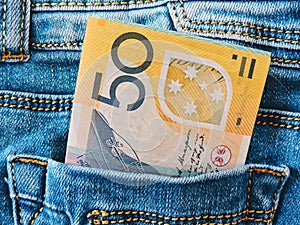 A collection of Australian banknotes.dollars in a jeans pocket, closeup.A few bills of one hundred dollars stick out .