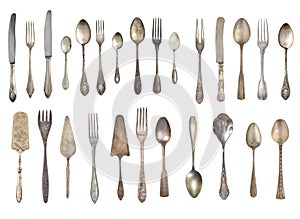 Collection of beautiful old vintage forks, spoons and knife isolated on white background. Top view. Retro silverware