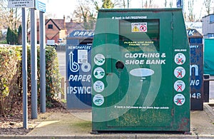 A collection bin for second hand clothes and shoes in a carpark