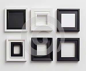 A collection of black and white picture frames arranged neatly against a white backdrop, showcasing a variety of sizes