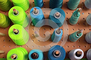 Collection of blue and green industrial spools of thread