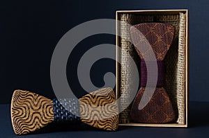 Collection of bow ties made of handmade wood, on a black background