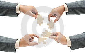 Collection of business hand holding a single piece of puzzle