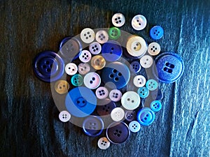 Big and small colored buttons on black