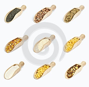 Collection of cereals on wooden spoons on white