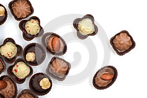 Collection of chocolates on a white background. Confectionery products, top view