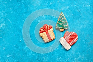 Collection of Christmas gingerbread on turquoise blue grunge background. Gingerbread in the shape of a Christmas tree, a gift and