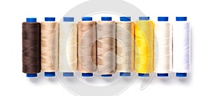 Collection of color thread spools isolated on white background. Sewing concept