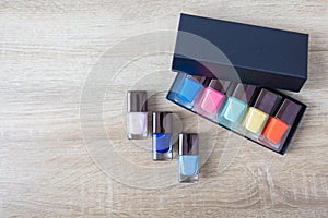 Collection of colored bottles of nail polish and gel. Layout for design.